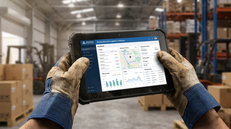 A dispatch manager tracking logistics on a rugged device under bright daylight..jpg